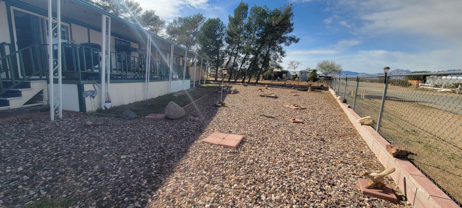 1435 West Perch Avenue Ridgecrest, CA 93555 - Photo 20 of 40 a view of a backyard with large trees