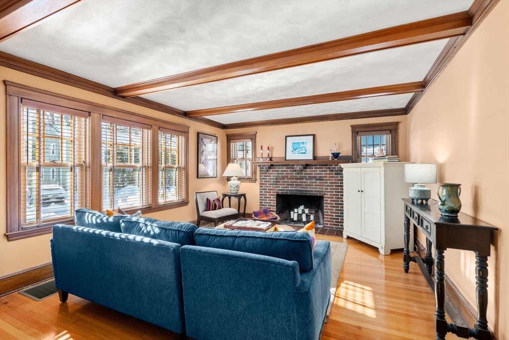 23 Newman Way, Unit 1 Arlington, MA 02476 - Photo 1 of 28 a living room with furniture and a fireplace