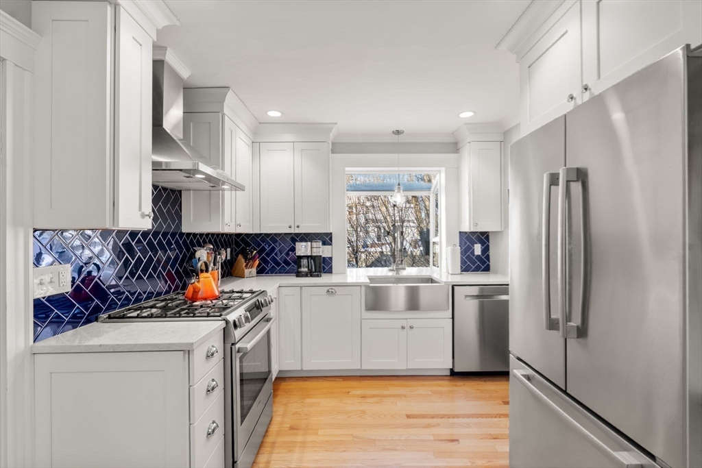 23 Newman Way, Unit 1 Arlington, MA 02476 - Photo 11 of 28 a kitchen with stainless steel appliances a refrigerator sink and cabinets