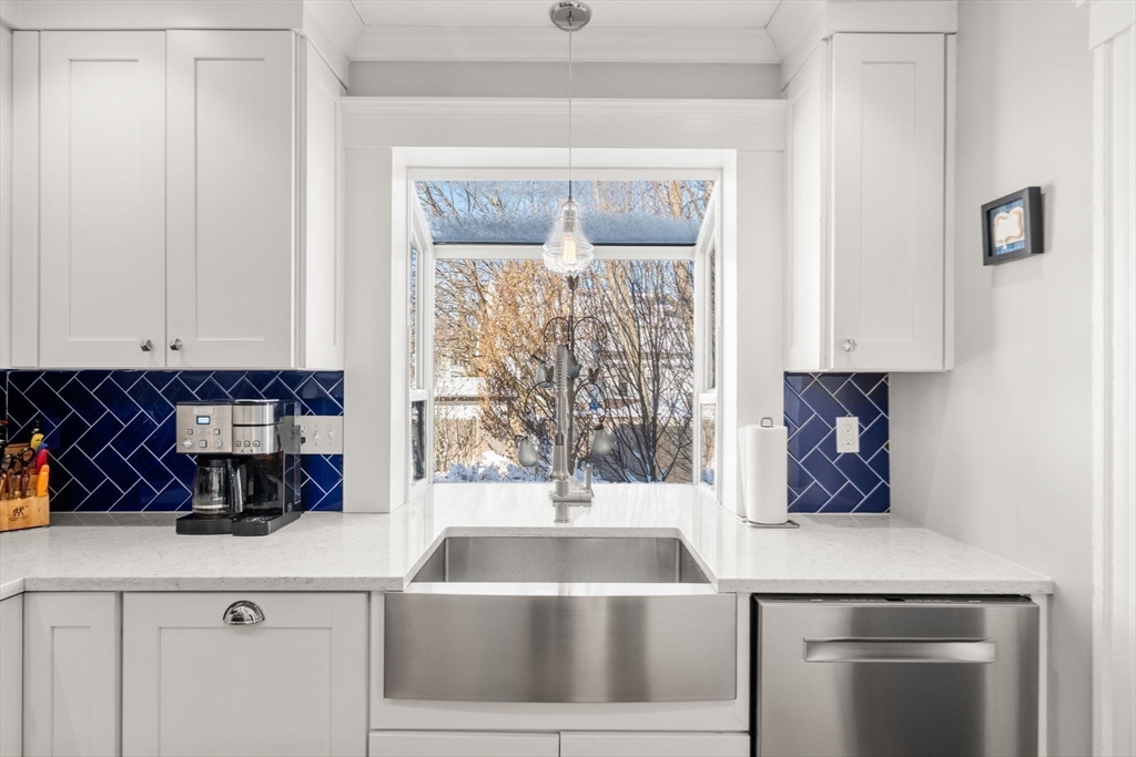 23 Newman Way, Unit 1 Arlington, MA 02476 - Photo 13 of 28 a kitchen with a sink and a refrigerator