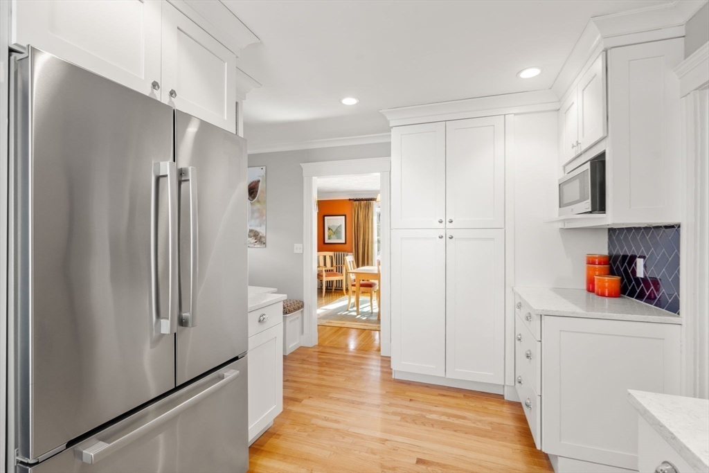 23 Newman Way, Unit 1 Arlington, MA 02476 - Photo 14 of 28 a view of a refrigerator in kitchen and an empty room