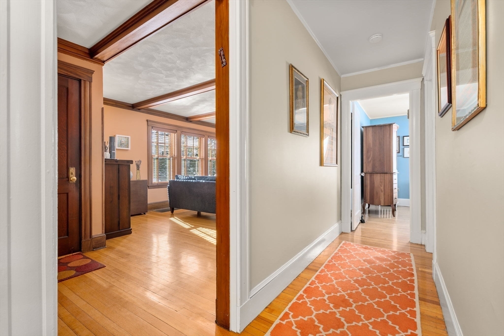 23 Newman Way, Unit 1 Arlington, MA 02476 - Photo 20 of 28 a view of a hallway with wooden floor and a living room