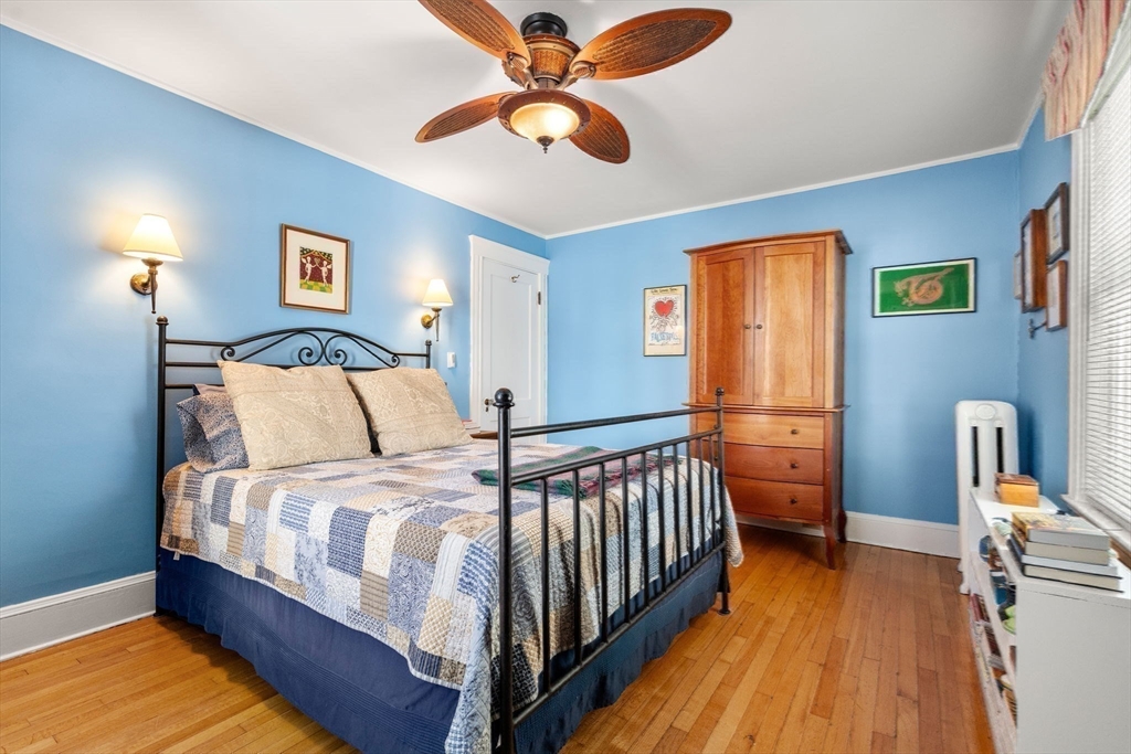 23 Newman Way, Unit 1 Arlington, MA 02476 - Photo 21 of 28 a bedroom with a bed and a chandelier