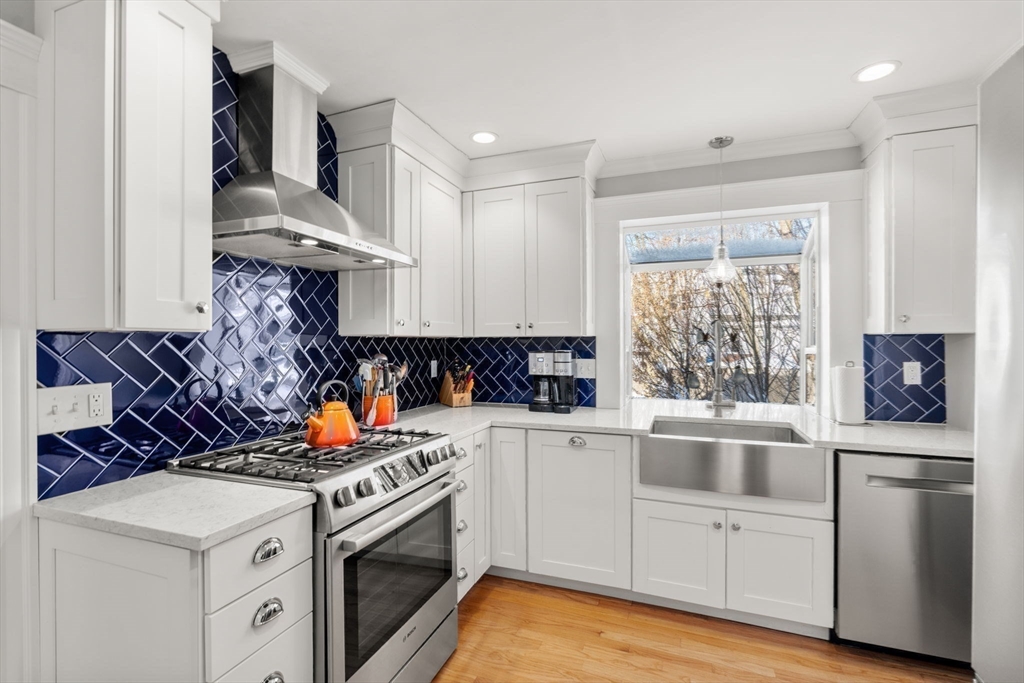 23 Newman Way, Unit 1 Arlington, MA 02476 - Photo 10 of 28 a kitchen with stainless steel appliances granite countertop a stove and a sink