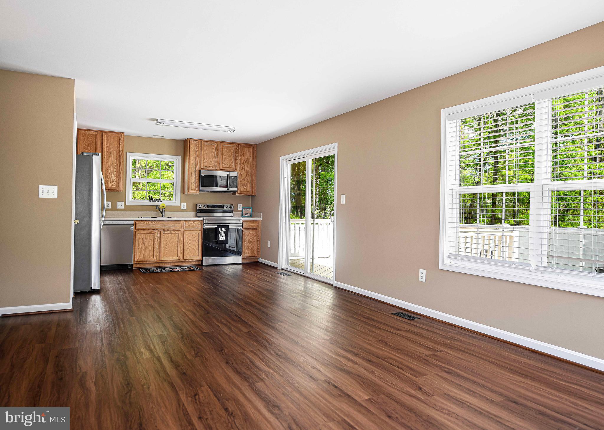 7226 Orth Road Sparrows Point, MD 21219 - Photo 15 of 51 an empty room with wooden floor fireplace and windows