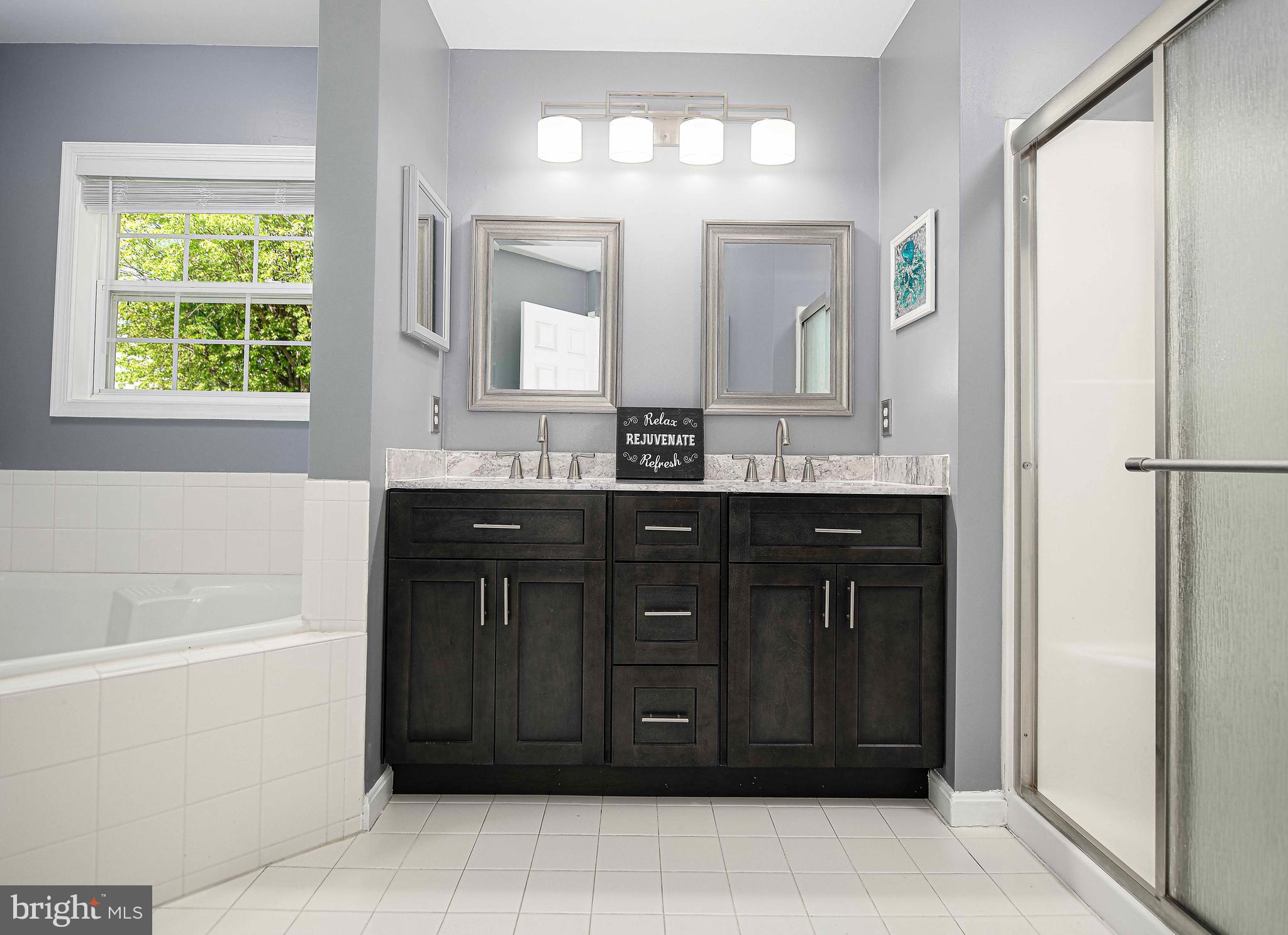 7226 Orth Road Sparrows Point, MD 21219 - Photo 40 of 51 a bathroom with a tub a sink and a mirror