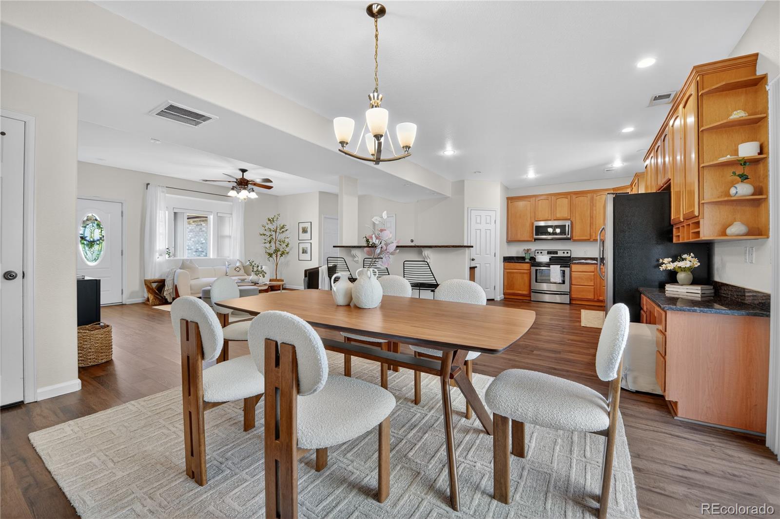 665 Kilmer Street Golden, CO 80401 - Photo 11 of 35 a view of a dining room with furniture and wooden floor