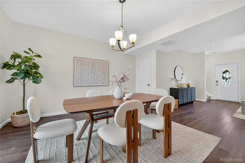 a view of a dining room with furniture wooden floor and chandelier