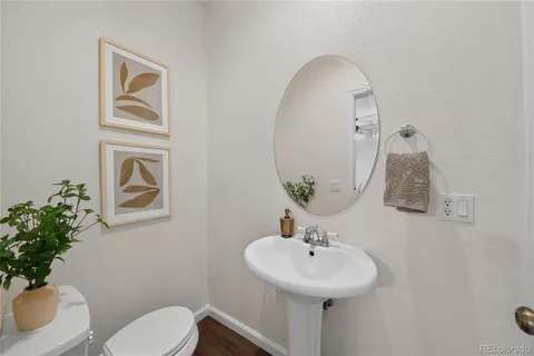 a bathroom with a sink mirror and toilet