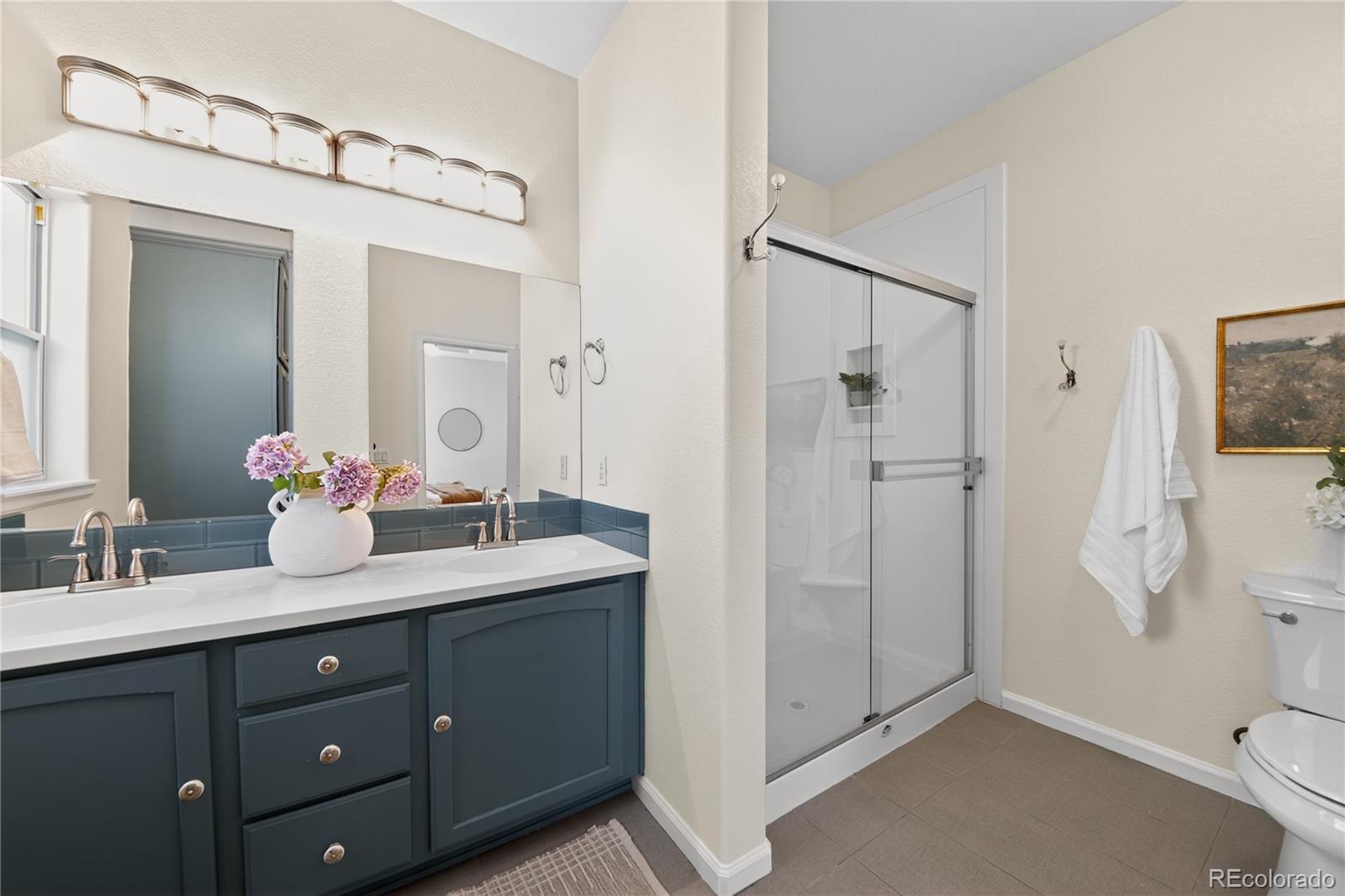 665 Kilmer Street Golden, CO 80401 - Photo 24 of 35 a bathroom with a double vanity sink mirror and shower