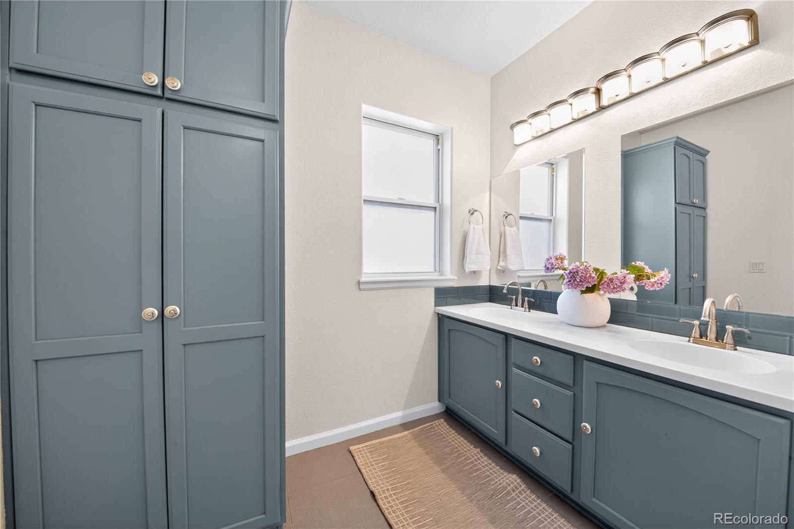665 Kilmer Street Golden, CO 80401 - Photo 25 of 35 a bathroom with a double vanity sink mirror and