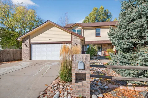 a view of a house with a yard and potted plants