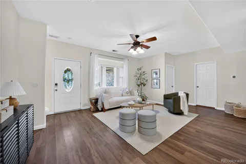 a living room with furniture and wooden floor