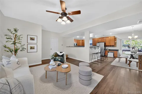 a living room with furniture and view of kitchen