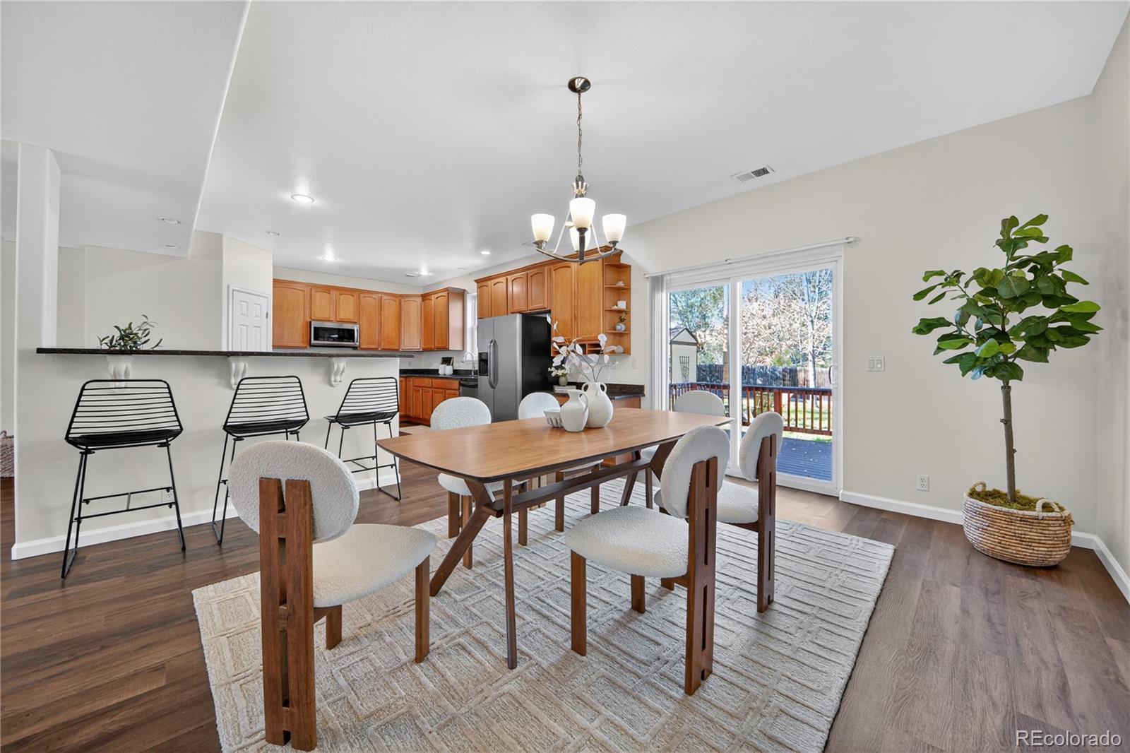 665 Kilmer Street Golden, CO 80401 - Photo 10 of 35 a view of a a dining room with furniture window and wooden floor
