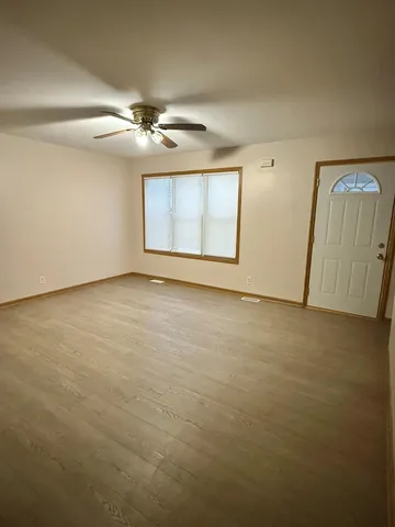 an empty room with windows and closet