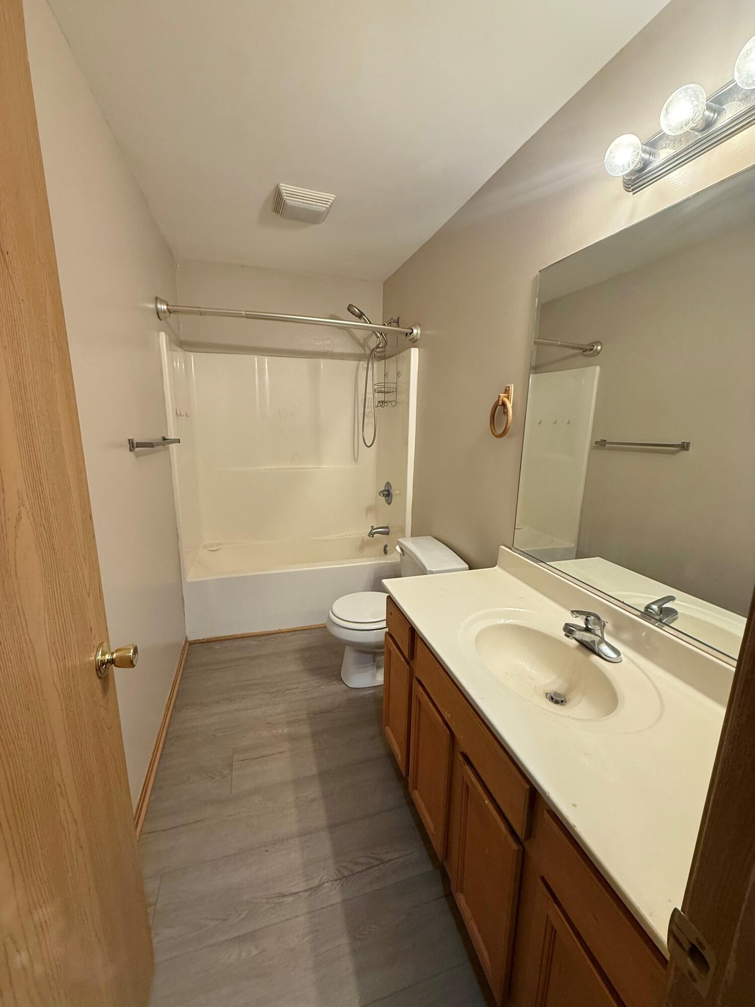 395 Plymouth Road, Unit B Valparaiso, IN 46385 - Photo 7 of 8 a bathroom with a sink a toilet a mirror and shower