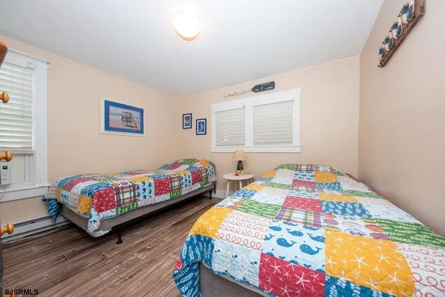 a bedroom with a bed and a dresser in it