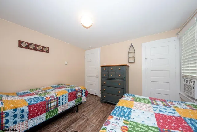 a bedroom with a bed and a dresser in it