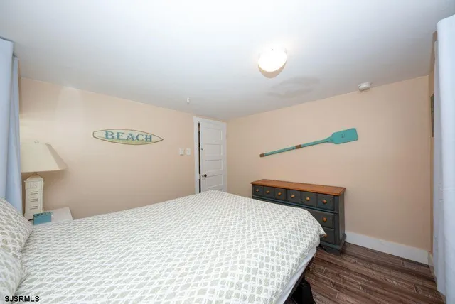 a bedroom with a bed and a night stand