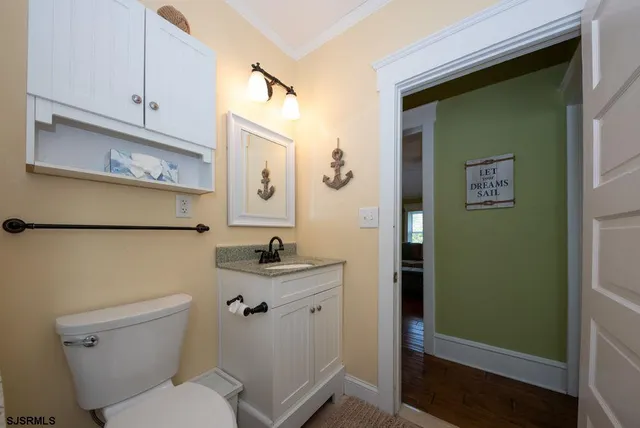 a bathroom with a toilet sink and mirror