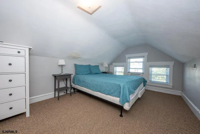 a bedroom with a bed closet and window
