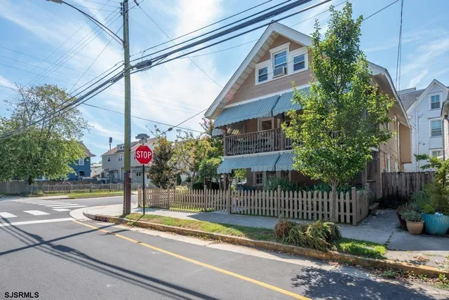 a view of street along with house and trees