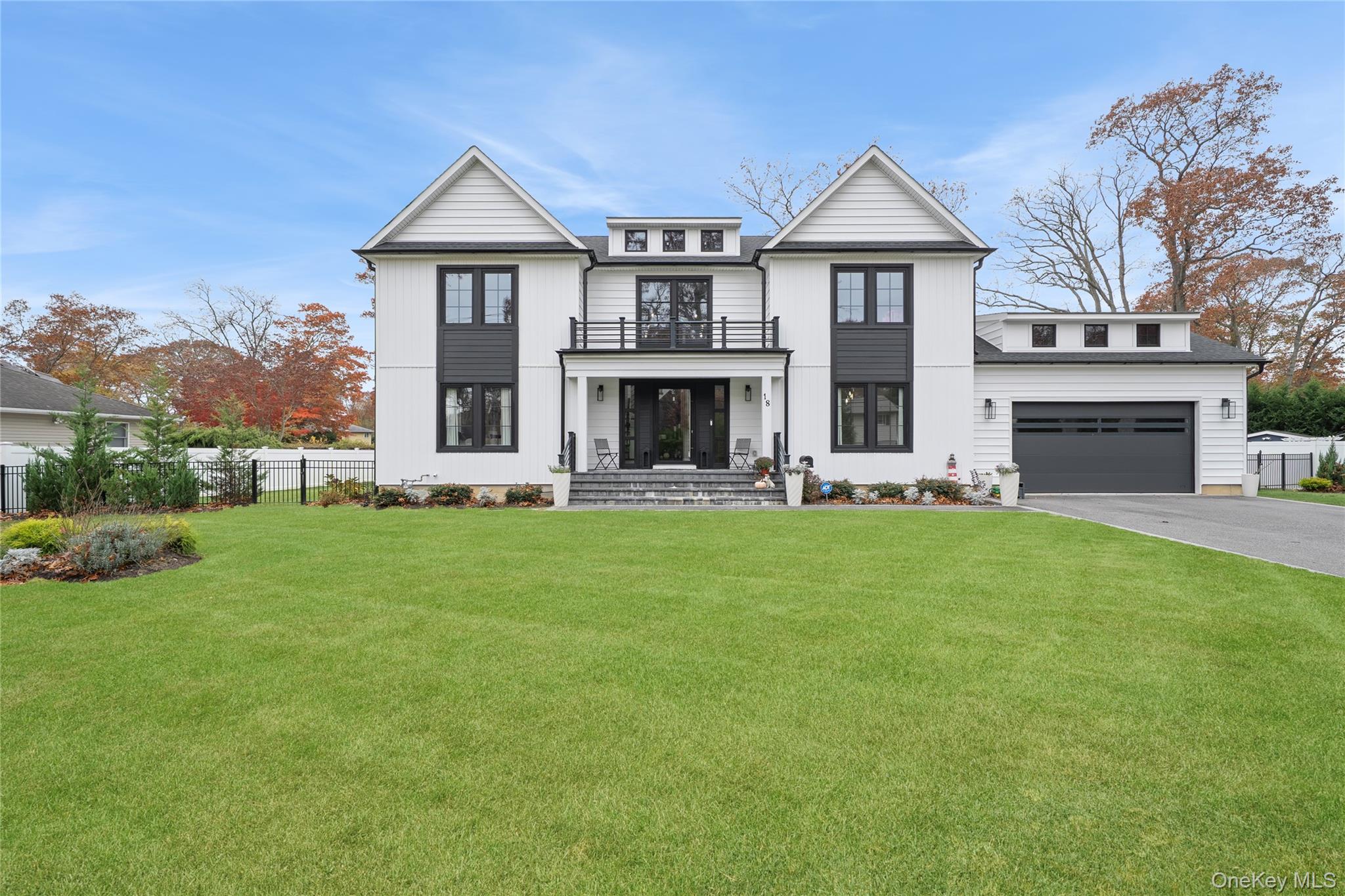 18 Timber Point Road East Islip, NY 11730 - Photo 1 of 34 a front view of a house with a garden and yard