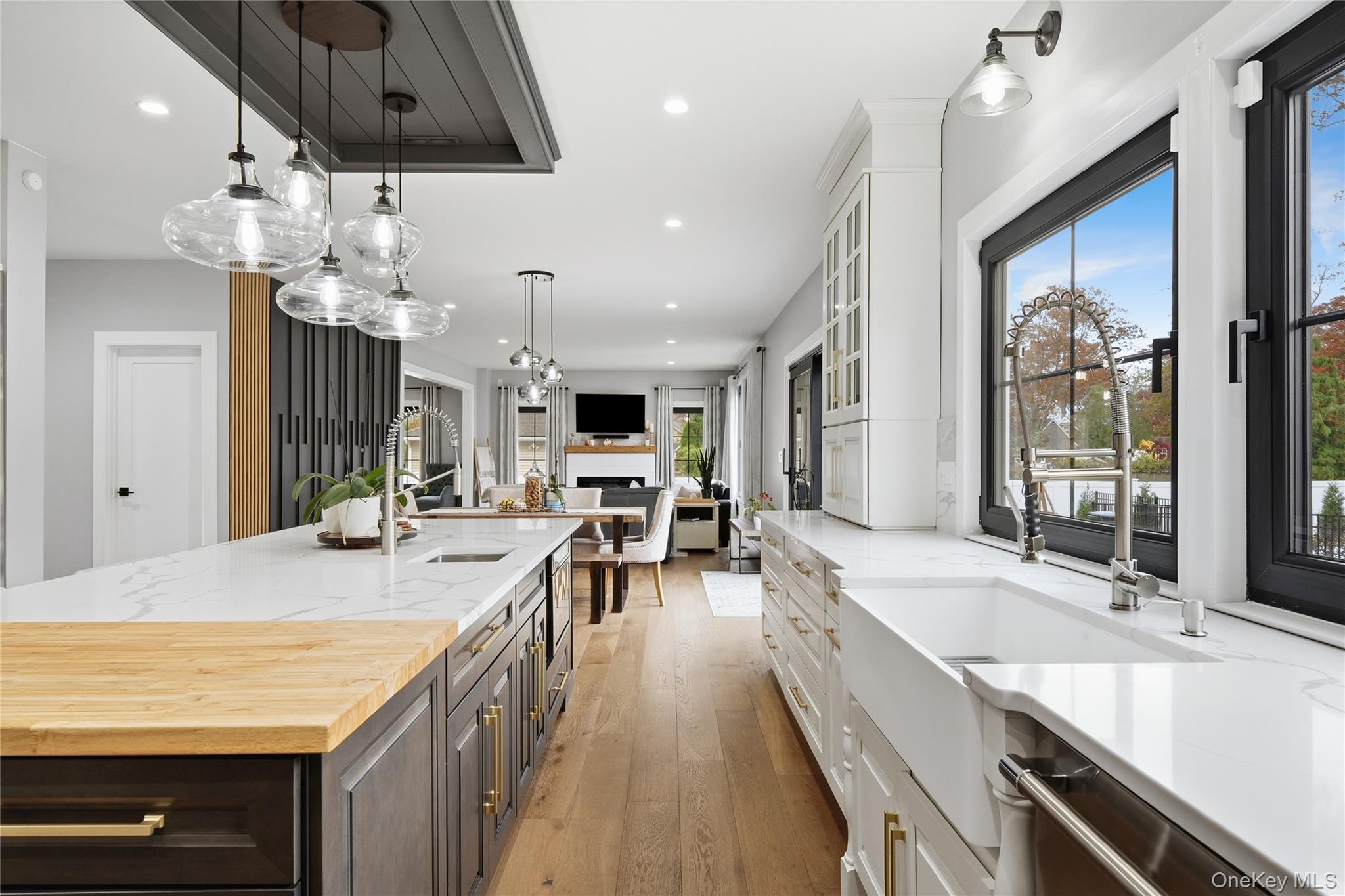 18 Timber Point Road East Islip, NY 11730 - Photo 10 of 34 a large kitchen with kitchen island a large counter space a sink appliances and living room view