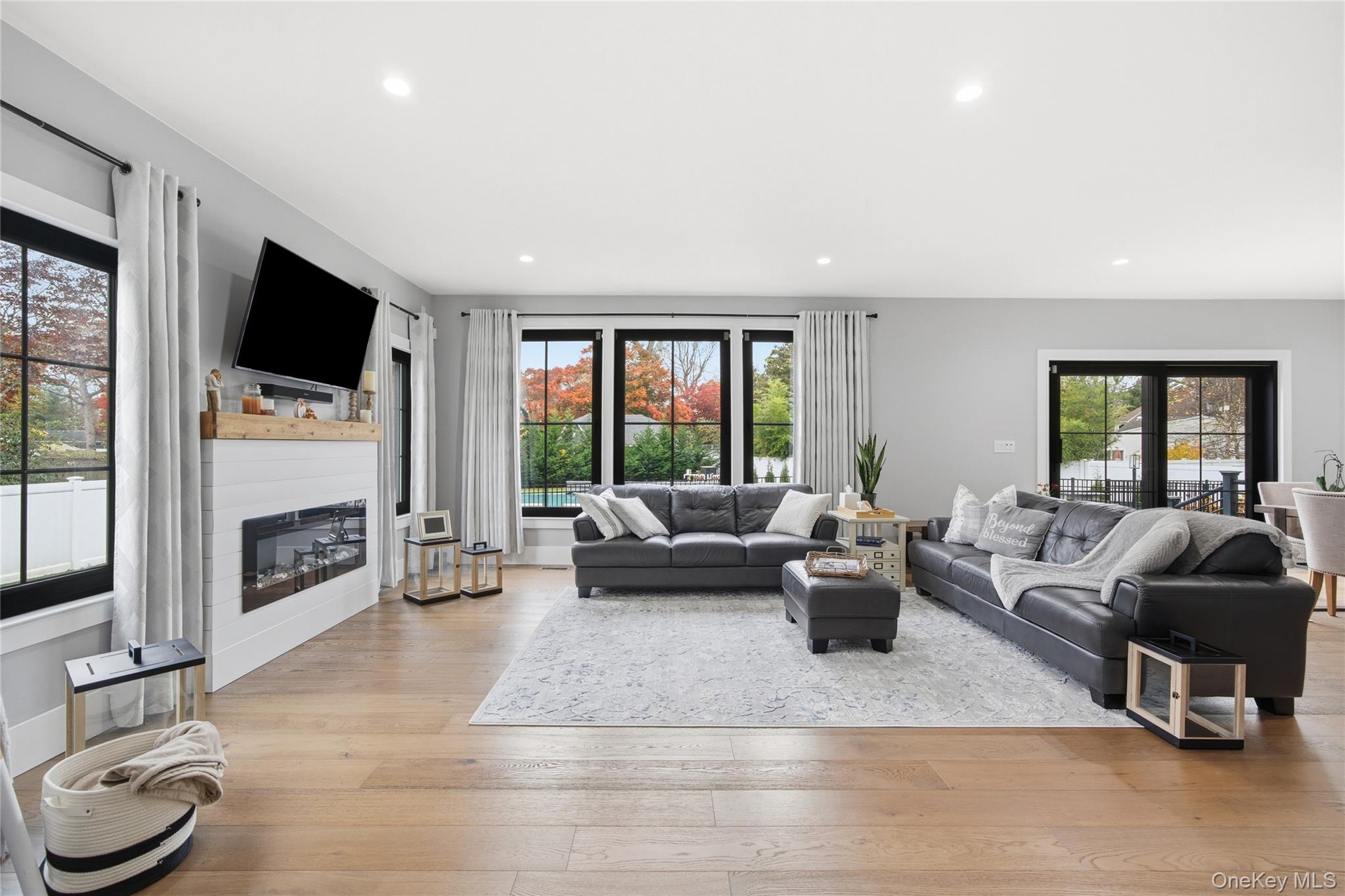 18 Timber Point Road East Islip, NY 11730 - Photo 14 of 34 a living room with furniture flat screen tv and a large window