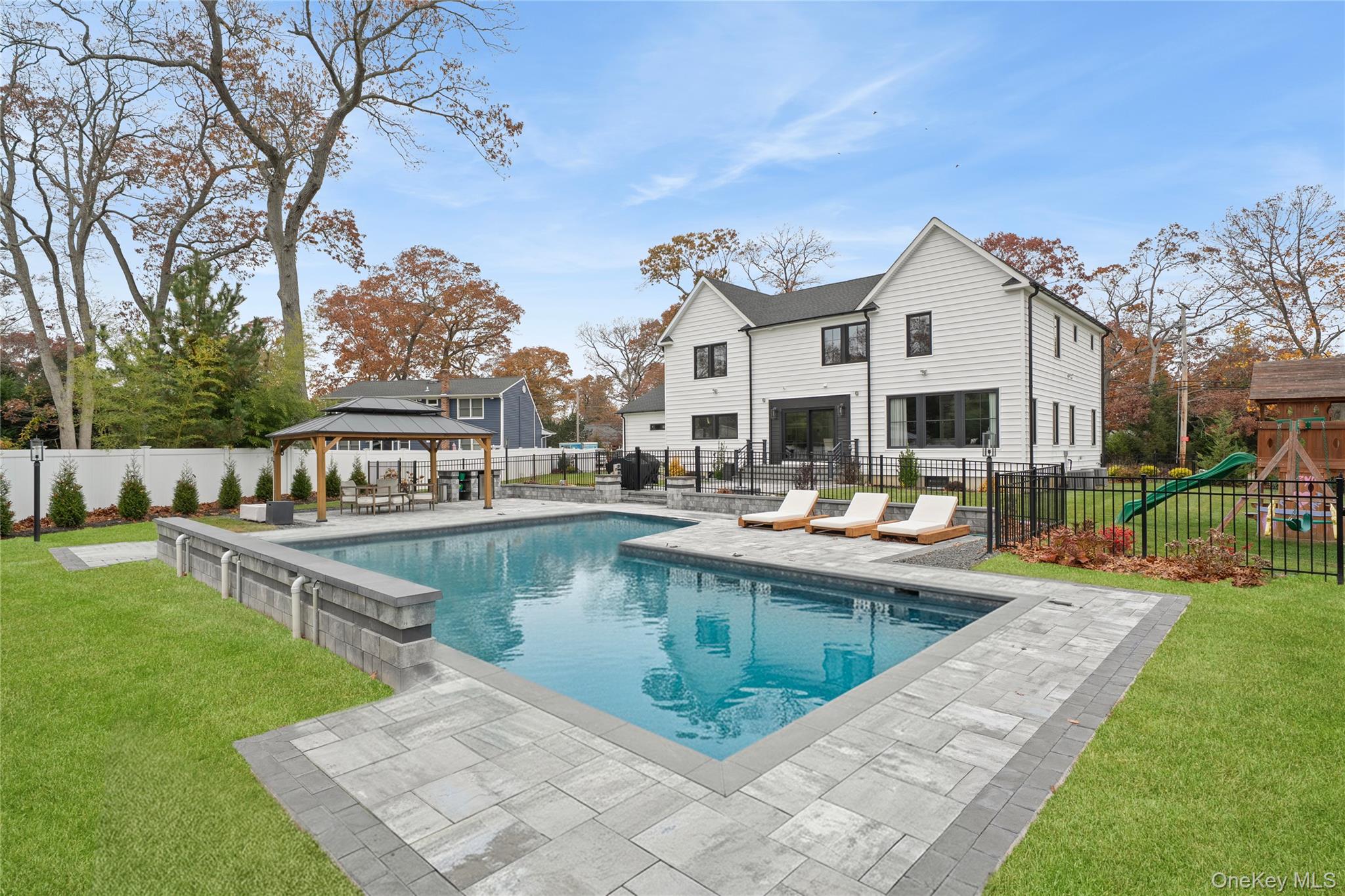 18 Timber Point Road East Islip, NY 11730 - Photo 2 of 34 a view of a house with swimming pool and sitting area