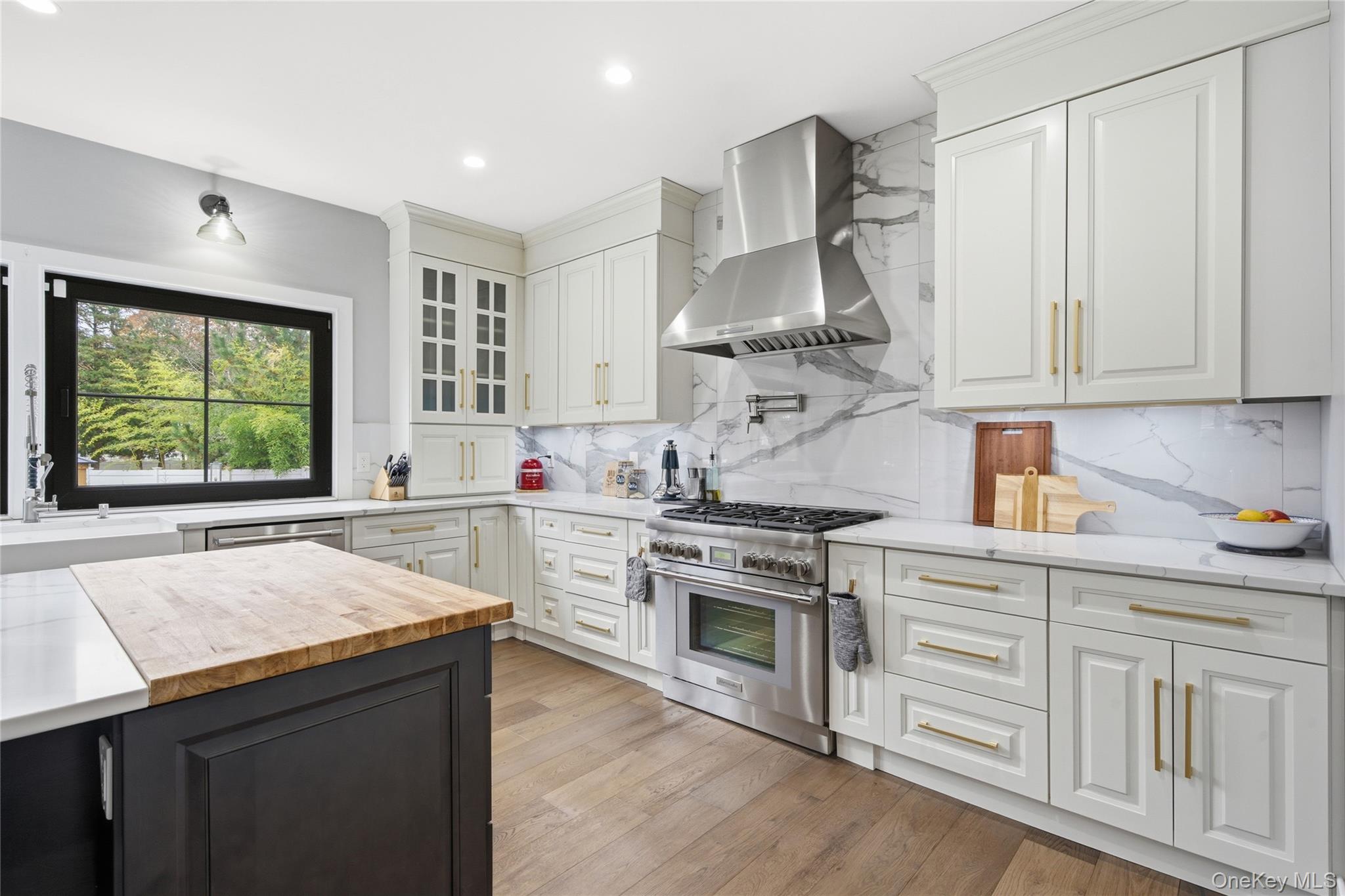 18 Timber Point Road East Islip, NY 11730 - Photo 9 of 34 a kitchen with white cabinets and appliances