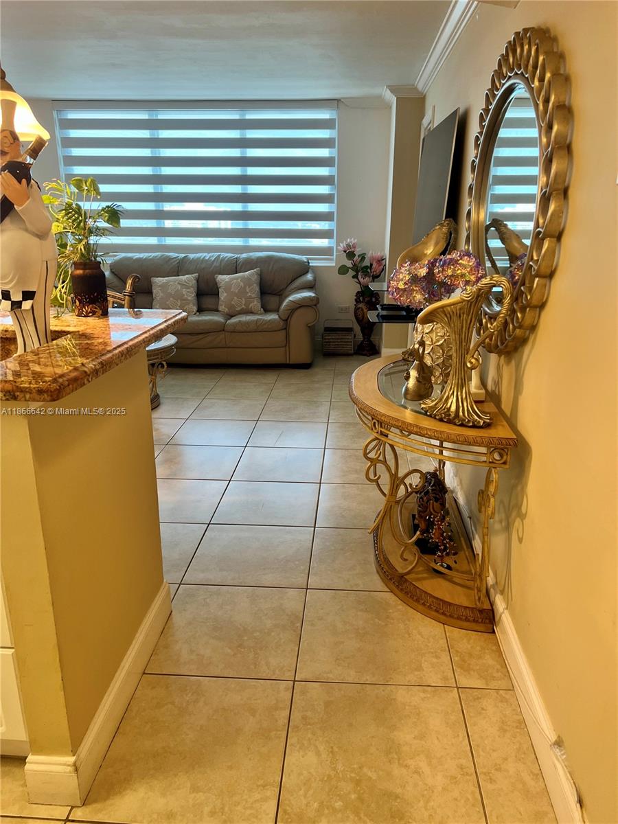 7135 Collins Avenue, Unit 1523 Miami Beach, FL 33141 - Photo 13 of 55 a living room with furniture and a floor to ceiling window