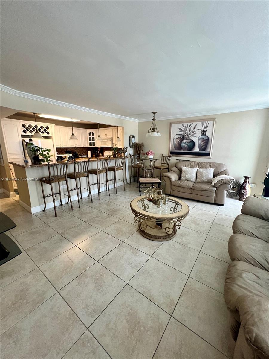 7135 Collins Avenue, Unit 1523 Miami Beach, FL 33141 - Photo 15 of 55 a living room with furniture and a table