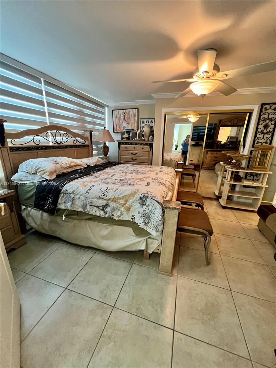 7135 Collins Avenue, Unit 1523 Miami Beach, FL 33141 - Photo 21 of 55 a bedroom with a bed gym equipment and view of living room