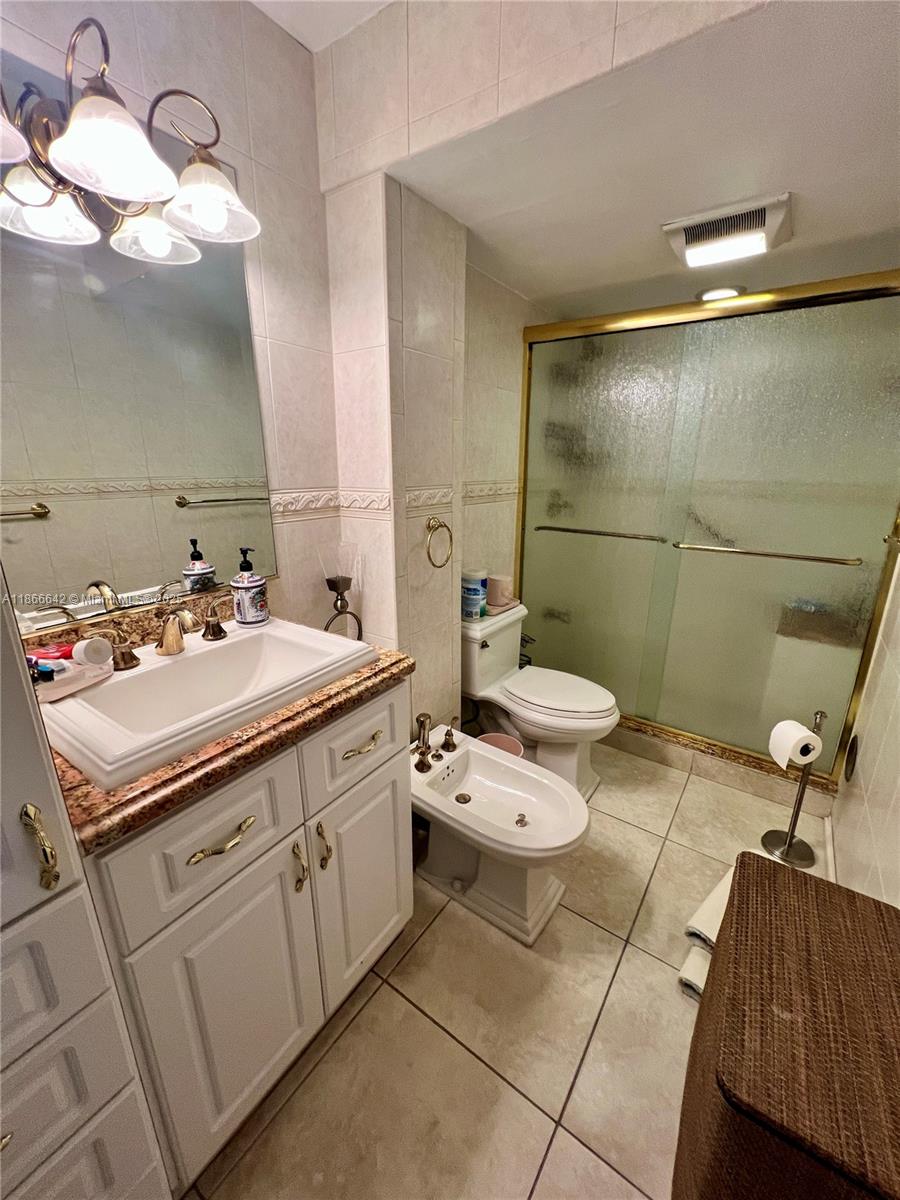 7135 Collins Avenue, Unit 1523 Miami Beach, FL 33141 - Photo 26 of 55 a bathroom with a sink and mirror