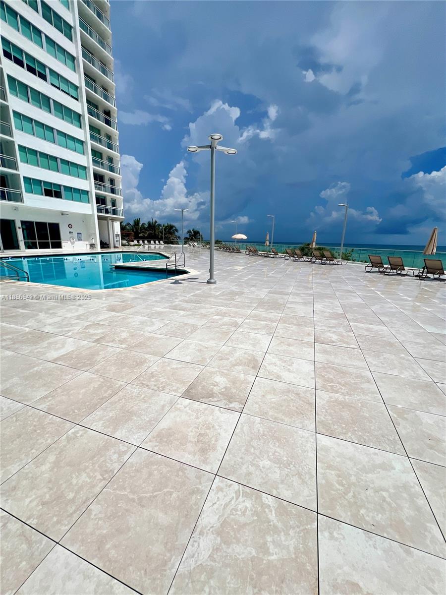 7135 Collins Avenue, Unit 1523 Miami Beach, FL 33141 - Photo 32 of 55 a view of a building with a yard