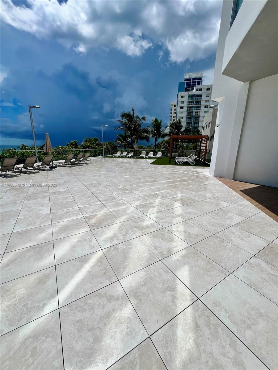 7135 Collins Avenue, Unit 1523 Miami Beach, FL 33141 - Photo 33 of 55 a view of a terrace with a bench