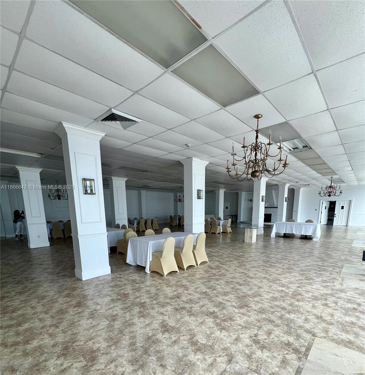 7135 Collins Avenue, Unit 1523 Miami Beach, FL 33141 - Photo 47 of 55 a living room with furniture and a chandelier