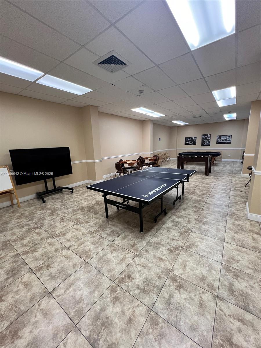 7135 Collins Avenue, Unit 1523 Miami Beach, FL 33141 - Photo 51 of 55 a living room with furniture a table and kitchen view