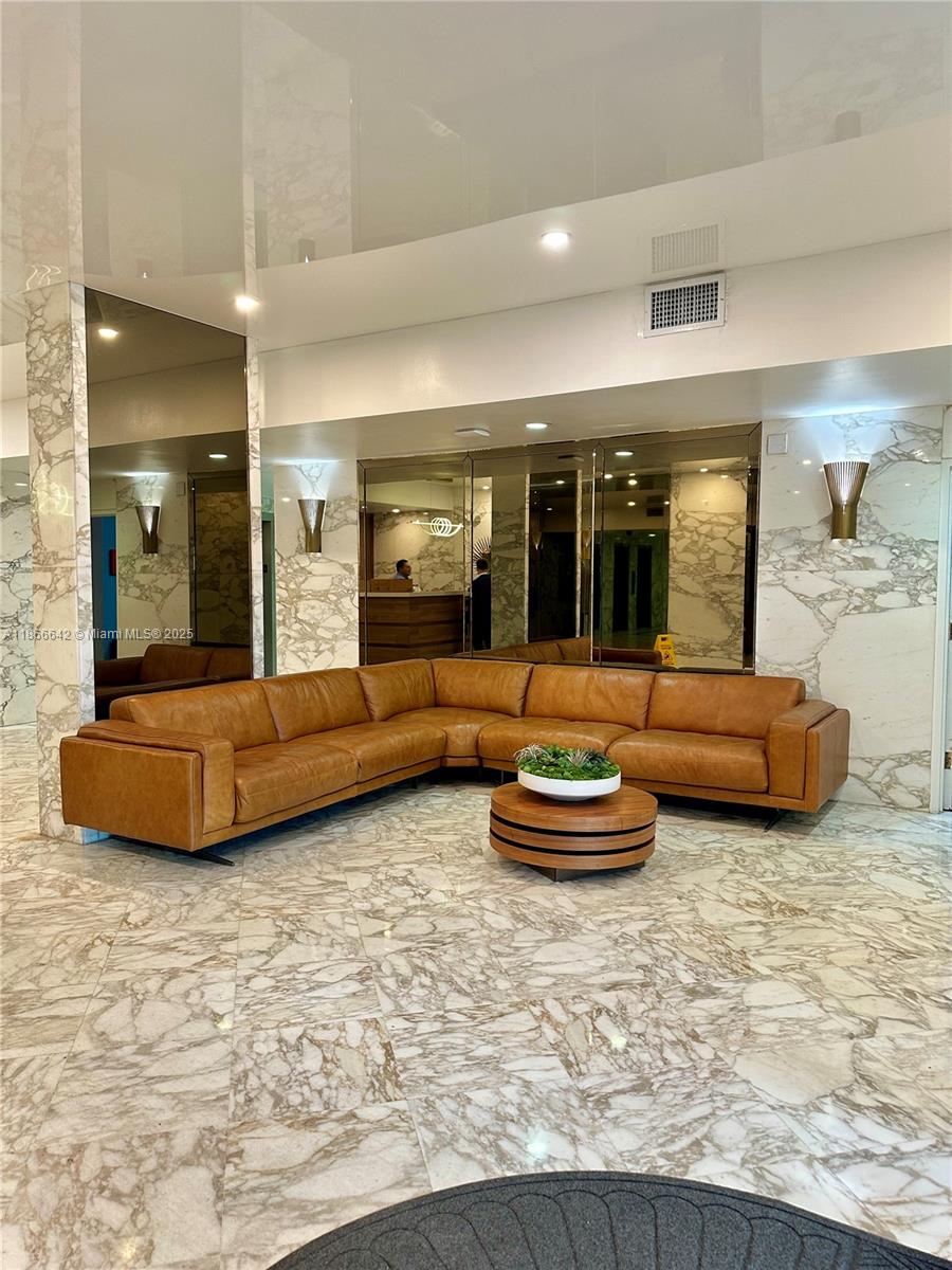 7135 Collins Avenue, Unit 1523 Miami Beach, FL 33141 - Photo 6 of 55 a living room with furniture and a wooden floor