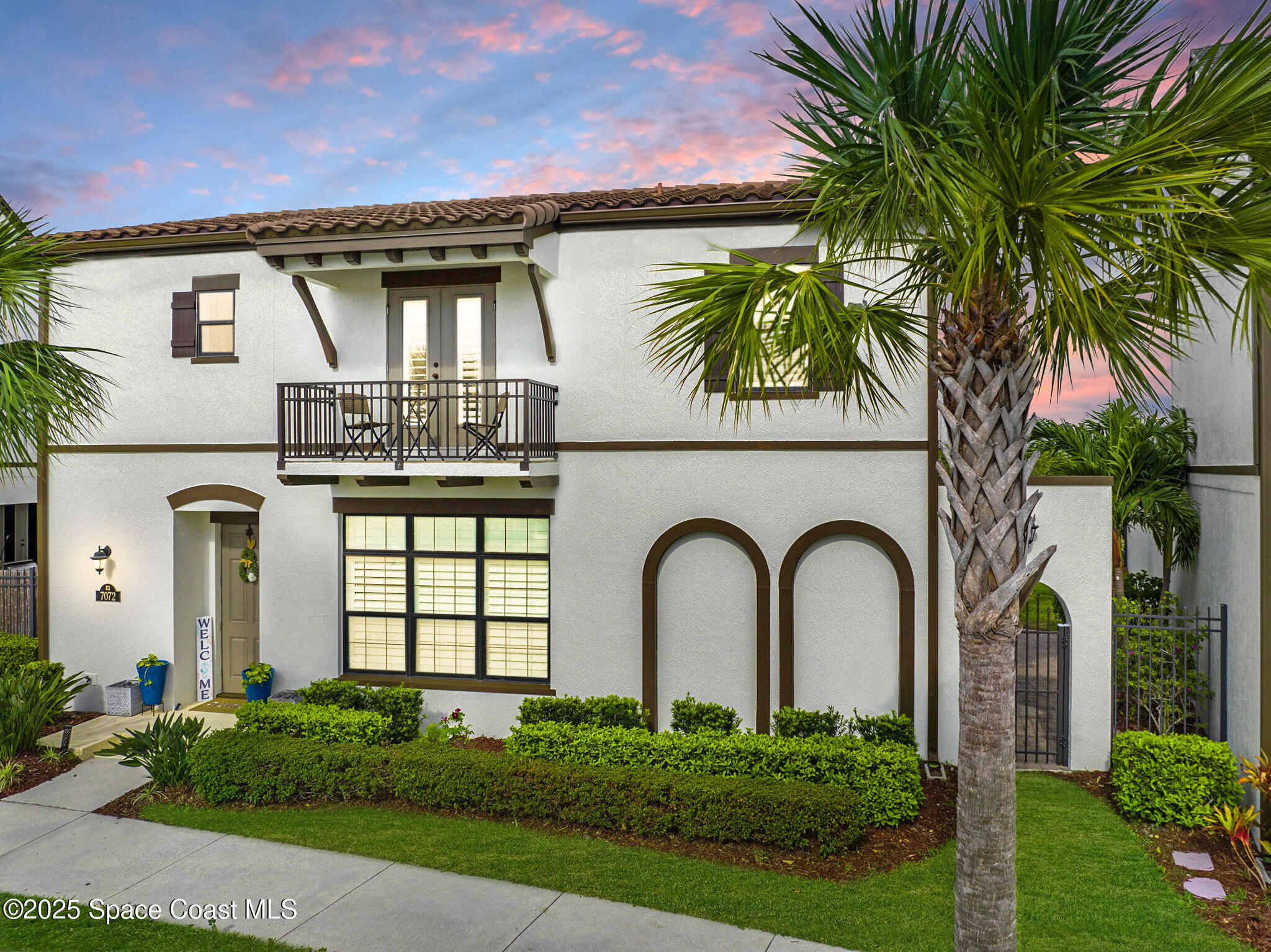 a front view of a house with a garden