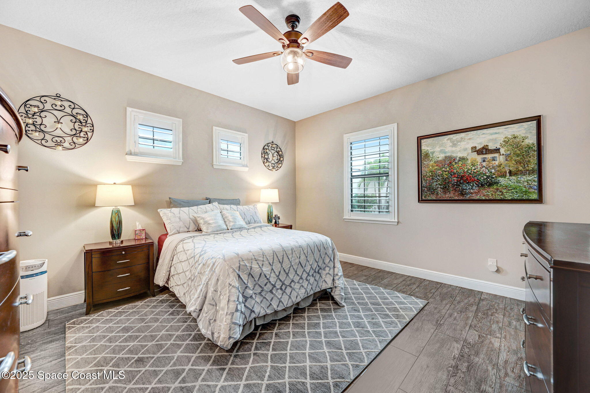 7072 Mercado Lane Melbourne, FL 32940 - Photo 11 of 32 a bedroom with a bed and a chandelier