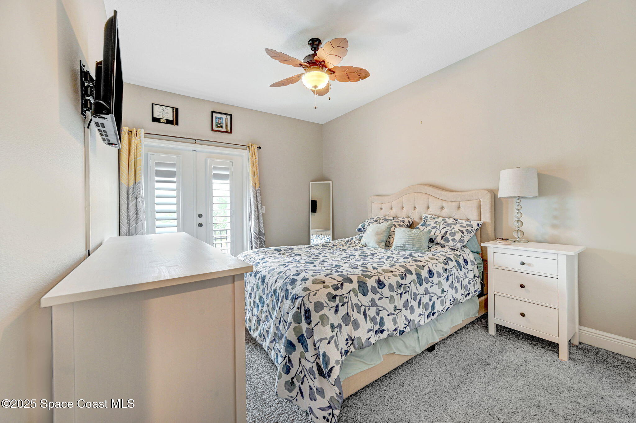 7072 Mercado Lane Melbourne, FL 32940 - Photo 24 of 32 a bedroom with bed and a chandelier