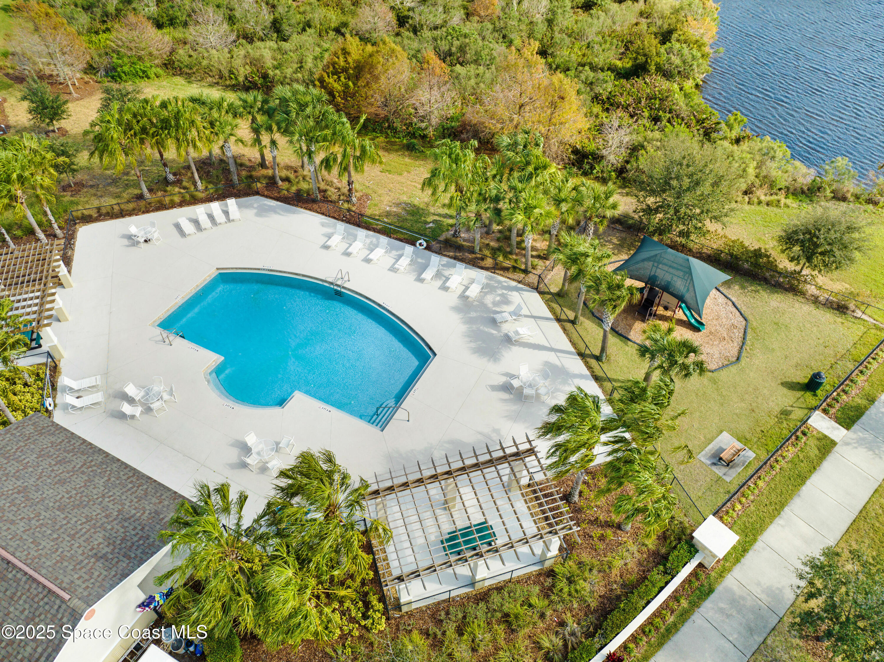 7072 Mercado Lane Melbourne, FL 32940 - Photo 32 of 32 a view of a swimming pool with a patio