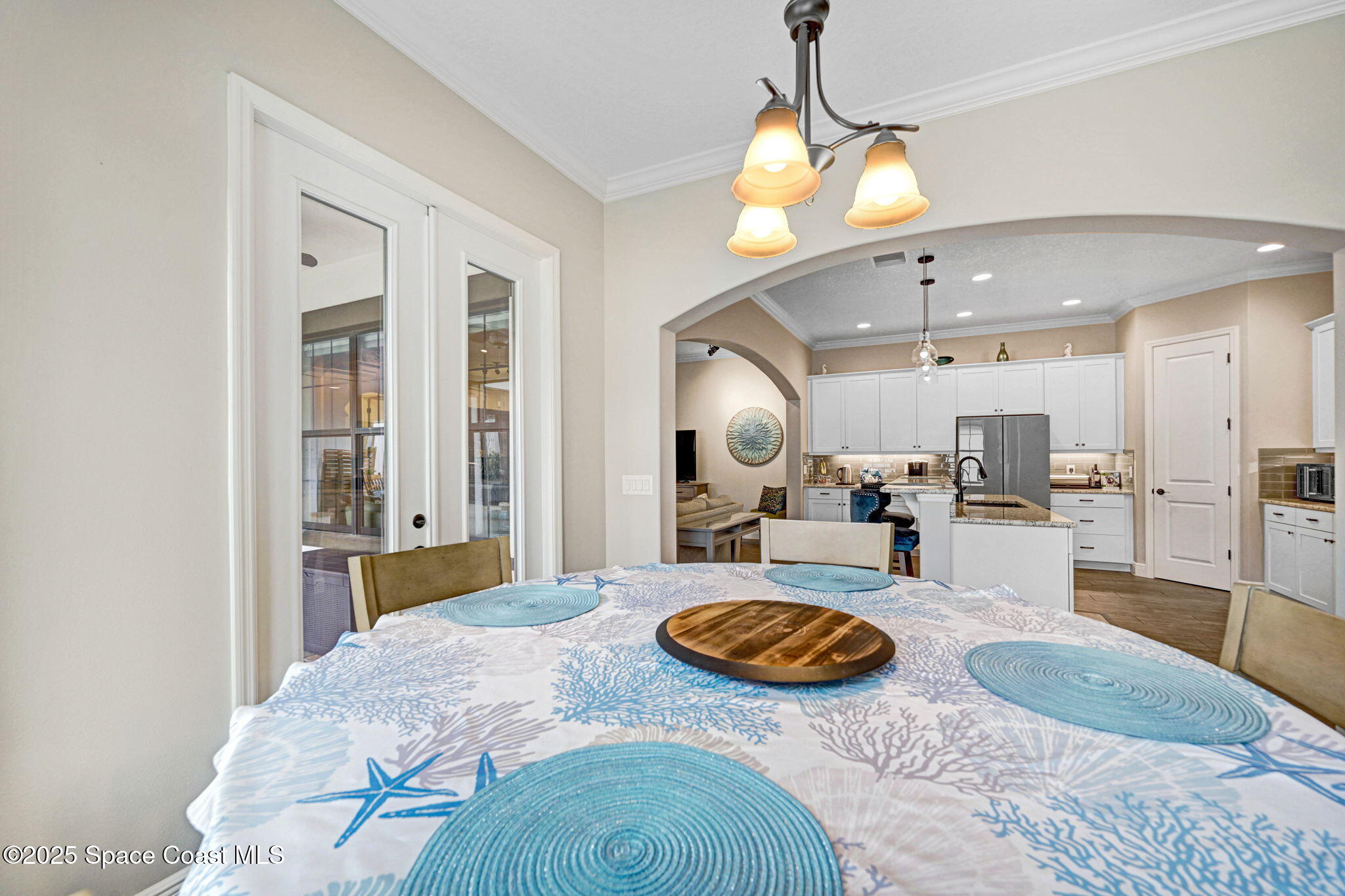 7072 Mercado Lane Melbourne, FL 32940 - Photo 9 of 32 a view of a kitchen and dining table with granite countertop wooden floor