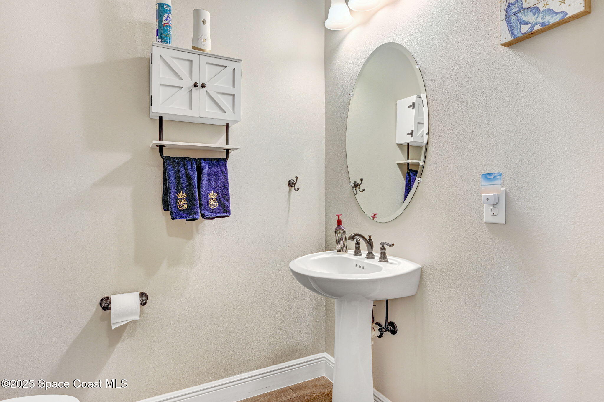 7072 Mercado Lane Melbourne, FL 32940 - Photo 10 of 32 a bathroom with a sink a mirror and a shower