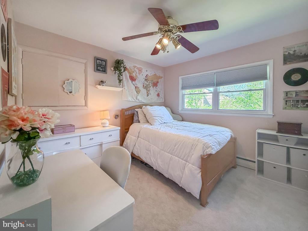 925 Big Oak Road Yardley, PA 19067 - Photo 37 of 51 a bedroom with a large bed and a chandelier