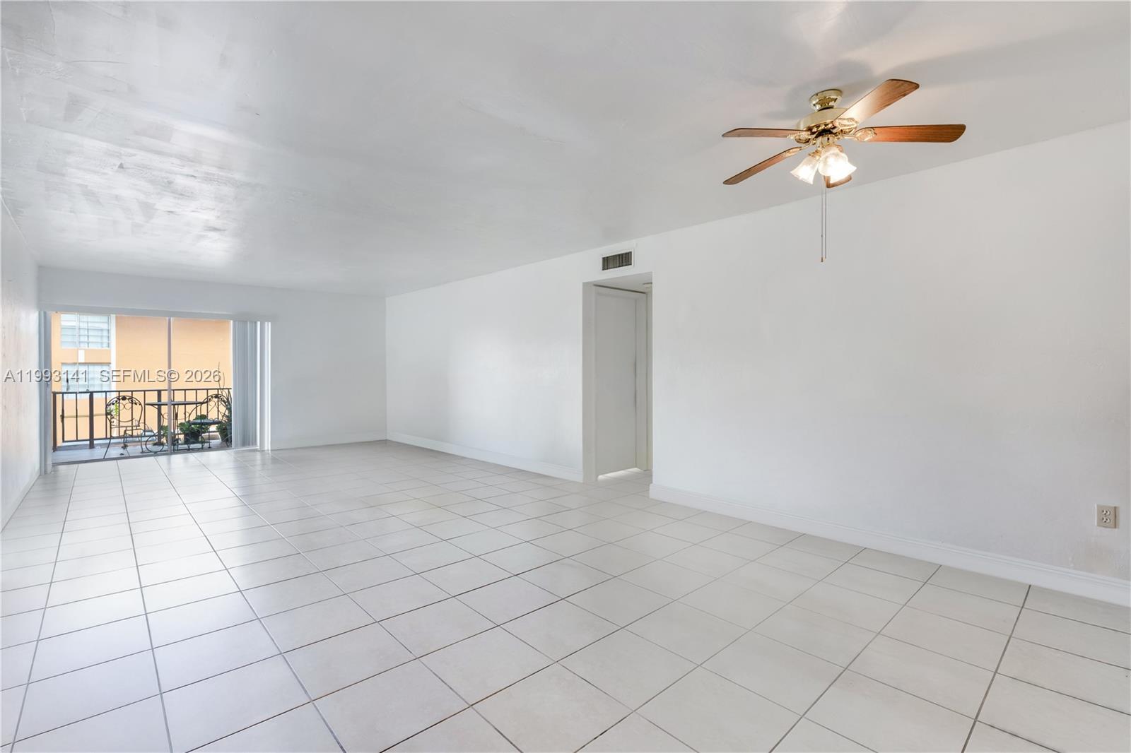 9423 Southwest 76th Street, Unit W21 Miami, FL 33173 - Photo 12 of 13 a view of an empty room with a window