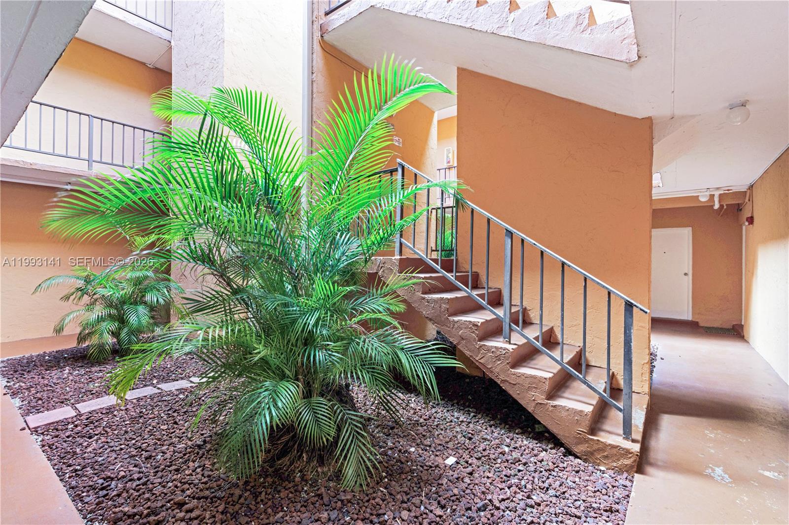 9423 Southwest 76th Street, Unit W21 Miami, FL 33173 - Photo 13 of 13 a view of a house with a yard